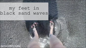 my feet in black sand waves.webp