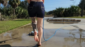 Barefoot Girl Catherine Sterling Pads Pretty Feet & Soft Soles on Rough Concrete while Power Washing in Denim Hotpants!.webp