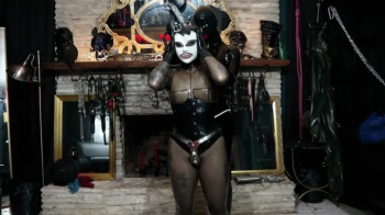 Rubberdoll is Gagged, Blindfolded, Belted in Chastity & Dommed in Dungeon, Zipped into Latex Bag & Vibrated until She Cu.webp