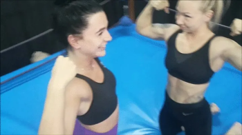 Two female fitness trainers wrestle blondie vs brunette.webp
