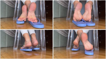 Solesmad dangling in lilac flip flops white pedi, back view from the ground.webp