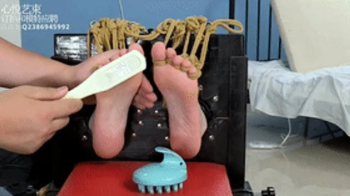 xy67-Mature Chinese girl in leather clothes is tied to a chair and tickles her feet like crazy.webp