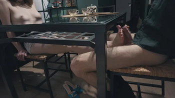 Petite girl with beautiful boobs doing hot footjob under the table.webp