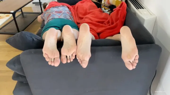 TWO GIRLS FEET FLIRTING FOOTSIE PLAY ON A SOFA - MP4 Mobile Version.webp