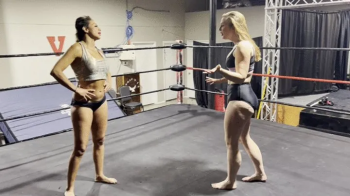 Two Barefoot Amazons Pin Each Other Multiple Times.webp