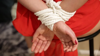 Sofi in a red dress tied to a chair with a black rope_Part 2.webp