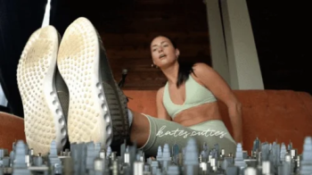 Giantess airing out stinky feet after workout.webp