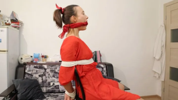 Sofi in a red dress tied to a chair with a black rope_Part 3.webp