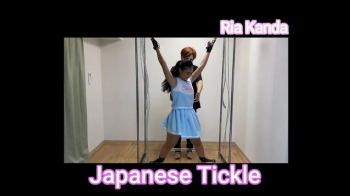 Ria Kanda - Tickling an Asian beauty in a cheerleader uniform, restrained in an X position.webp