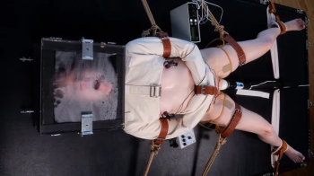 Heads or Tails- - Charlee Chaste and Elise Graves - With their head locked in a box and their body heavily restrained, C.webp