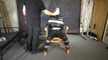 Alice taped to a Chair and Tapegagged in Shiny Nylon Downjacket.webp