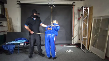 Ms Ungeniert bound, gagged and spanked in a shiny PVC Saunasuit.webp