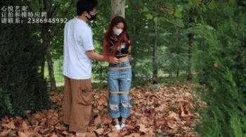Chinese Bondage Foot Fetish - xy231-A red-haired Chinese girl in jeans was tied to a rope and shackl.webp
