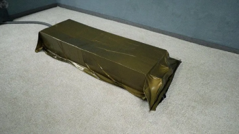 Bondage by boxes in a gold vacuum bed.webp
