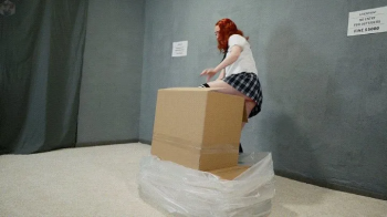 Schoolgirl in a warehouse or vacuuming in a box.webp