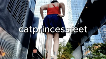 NYC giantess between skyscrapers, sandals, long toes and soles show.webp