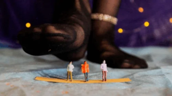 Three little guys under the feet of a giantess.webp