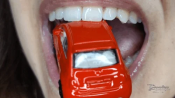 Licking a tiny car.webp