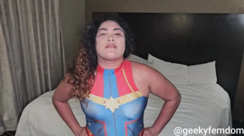 Captain Marvel dominates a wimp (played by Kim Chi).webp