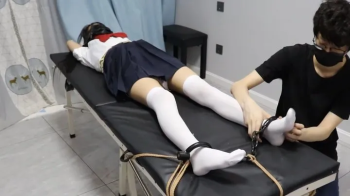 Japanese School Girl in Shackles Handcuffs Tied To Table And Tickled.webp