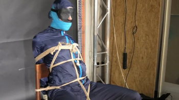 Marie bound and gagged in shiny nylon Rainwear.webp