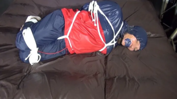 Sandra bound and gagged in shiny nylon Rainwear.webp