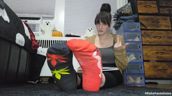Ignoring you, flipping you off and telling you how pathetic you are while you stare at my socked feet.webp