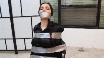 Teacher Lola Anderson humiliated in tight tape bondage by one of her students!.webp