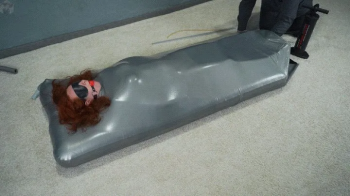 Sonya gagged in a gray vacuum mattress bed.webp