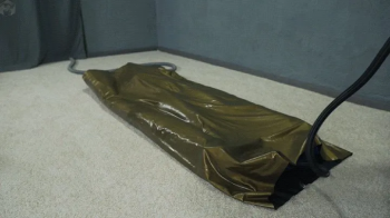 Sonya in a gold vacuum bed on a vibro mattress.webp