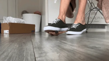 Giantess in sneakers finds tiny man in her shoe.webp