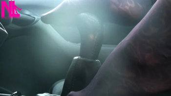 Caressing and footplaying with the wheel and the shift stick in violet patterned pantyhose.webp