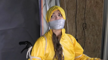 Watch Marie bound to a Wheelchair and tightly gagged in shiny nylon Rainwear.webp
