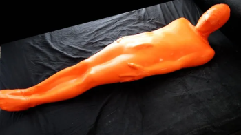 Trapped in a skintight orange latex sack.webp
