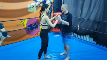 Taekwondo girl wrestles.webp