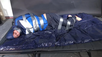 Myxxxy bound and gagged in shiny nylon blue Rainwear trying to free herself.webp