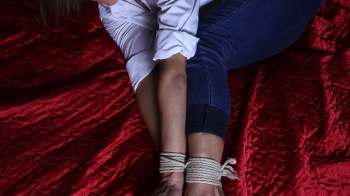 Delta- barefoot girl in white shirt with rolled up sleeves and blue skinny cuffed jeans, balltied with rope, wiggles on.webp