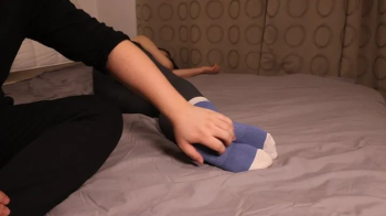Chinese woman is tickled in cotton socks.webp