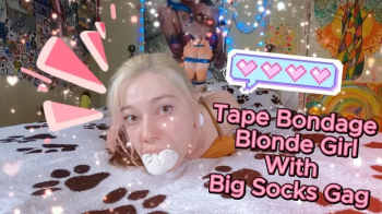 Tape Bondage Blonde Girl With Big Socks Gag.webp