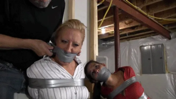 d2505GRLX2-Stuff and tape a gag in her mouth so she can't warn her friend.webp