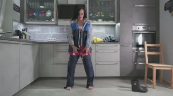Amira in layers of rainwear and bondage.webp