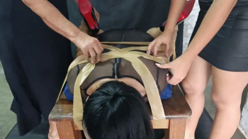 Woman bound completely with plastic tape to receive lots of tickling (2).webp