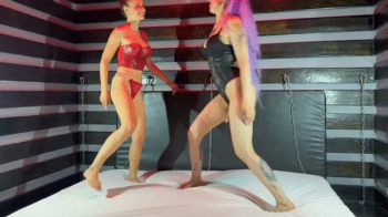 Two sexy dominas in lingerie wrestle.webp