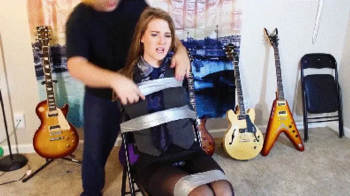 Remastered and Upscaled at 1080 and 60 FPS! Ashley the accountant tightly taped up to a chair and wraparound tape gagged.webp