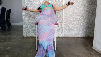 A mermaid is tickled all over her body while she is completely tied up (2).webp