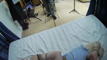 Barefoot Amy in black bra and jeans shorts, hogtied with hemp rope, is tickled and teased by Blackshark - view from her.webp