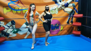 Domina vs fem wrestler in a sexy leotard.webp