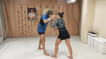 BJJ girl wrestles a guy.webp