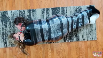 Cara and Minx - Friends Wrapped, Wriggling and Double Ball Gagged (WMV Format).webp