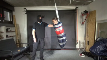Shinynylonartsbound - Marie taped and suspended in shiny nylon Rainwear.webp